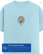 Front view of LUUM’s Mugiwara Legends: Nami t-shirt in Baby Blue, featuring her stained-glass inspired portrait and quote. Part of DailyPrints Collection. Belief. Woven and Worn.