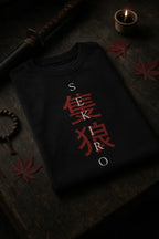 LUUM's Folded black t-shirt with vertical SEKIRO design, placed on dark wooden surface with katana, prayer beads, and red maple leaves. Part of DailyPrints Collection. Belief. Woven and Worn.