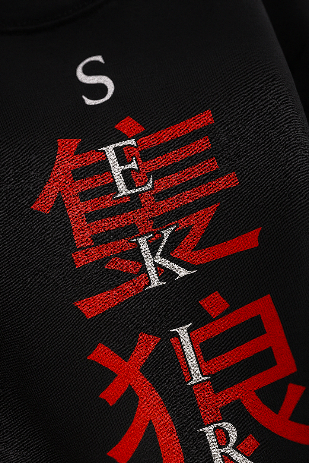 LUUM's Close-up of SEKIRO lettering intersected with red Kanji, showing matte DTG print texture on soft cotton weave. Part of DailyPrints Collection. Belief. Woven and Worn.