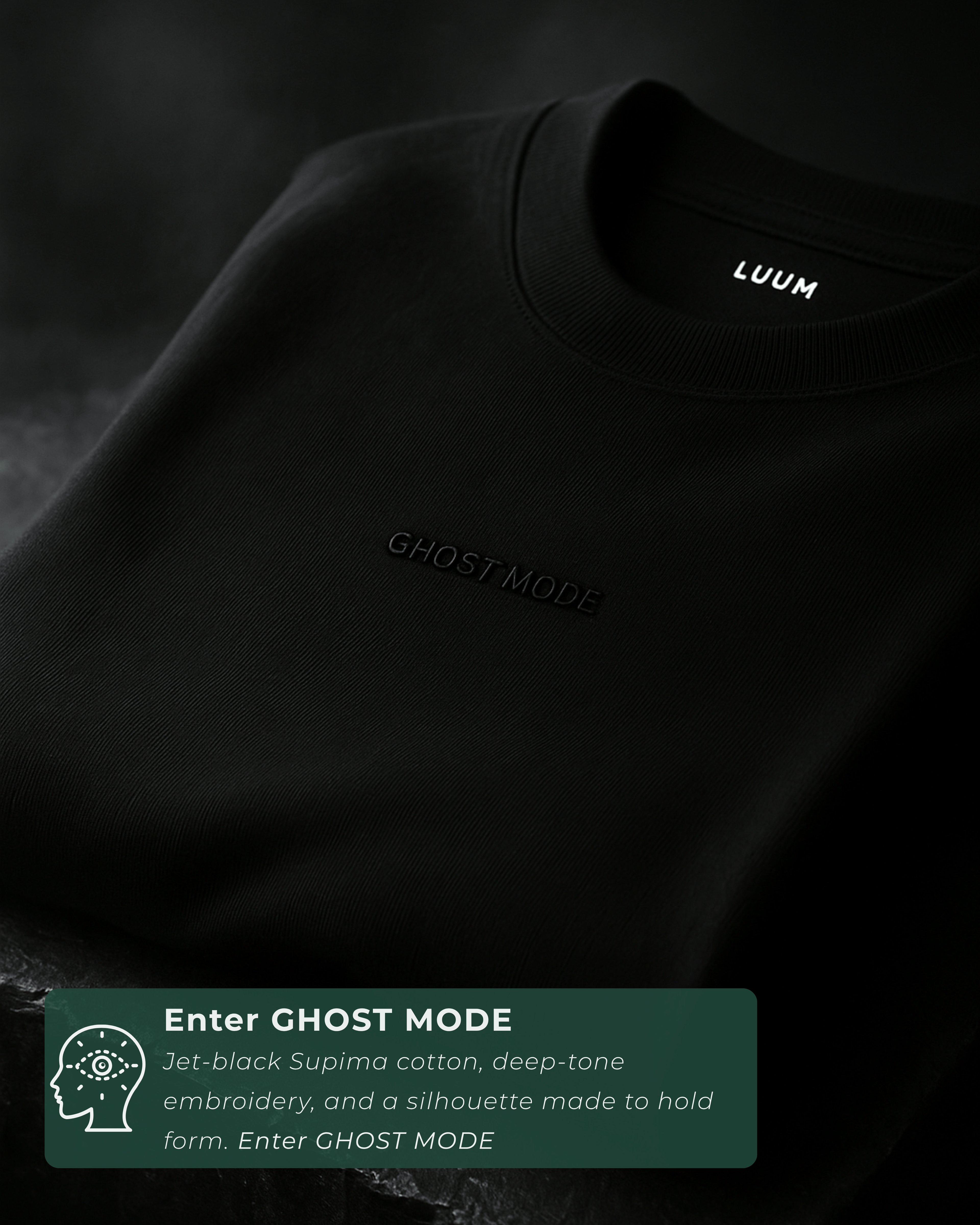 Folded cinematic shot of LUUM's black Ghost Mode tee with embroidered text visible. Part of Threadmark Collection. Belief. Woven and Worn.
