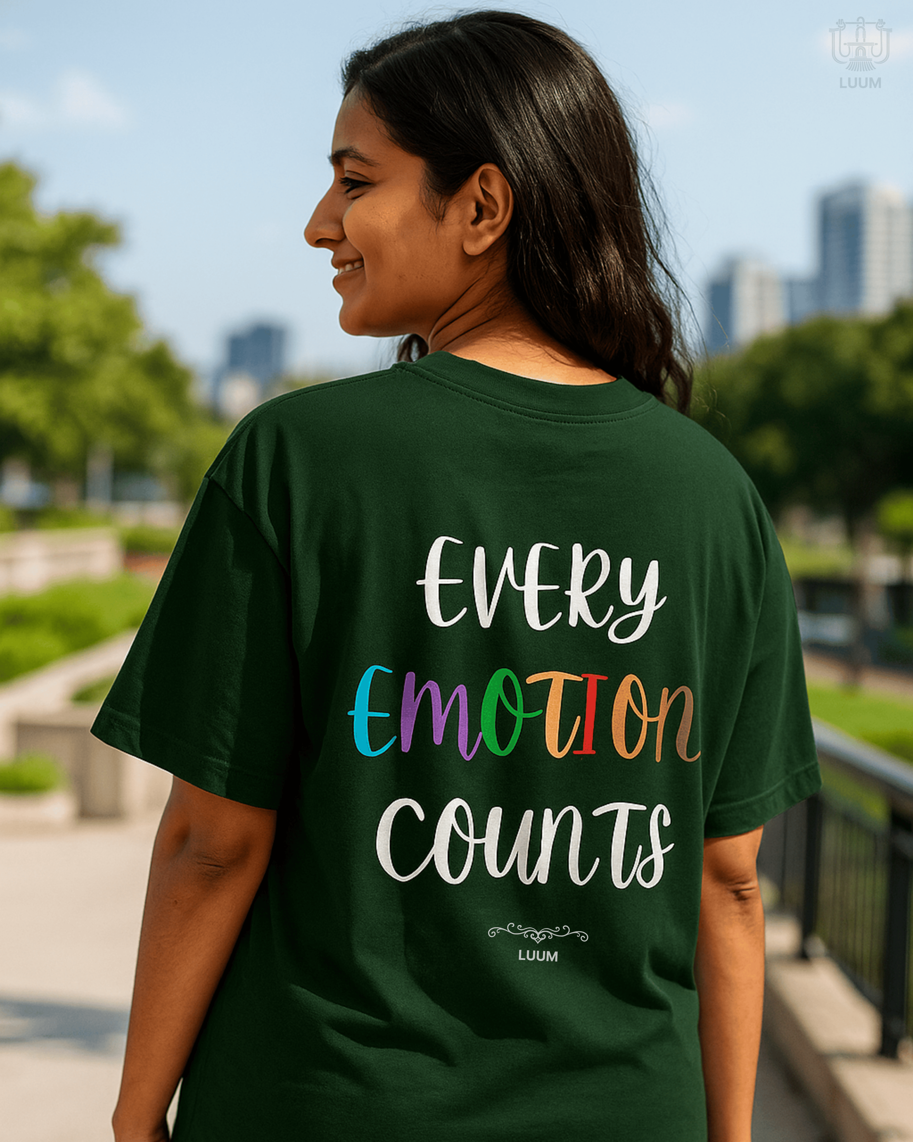 A model wearing LUUM's Every Emotion Counts tee in a natural setting, expressing emotion, highlighting the shirt’s message of openness and authenticity. Part of Threadmark Collection. Belief. Woven and Worn.