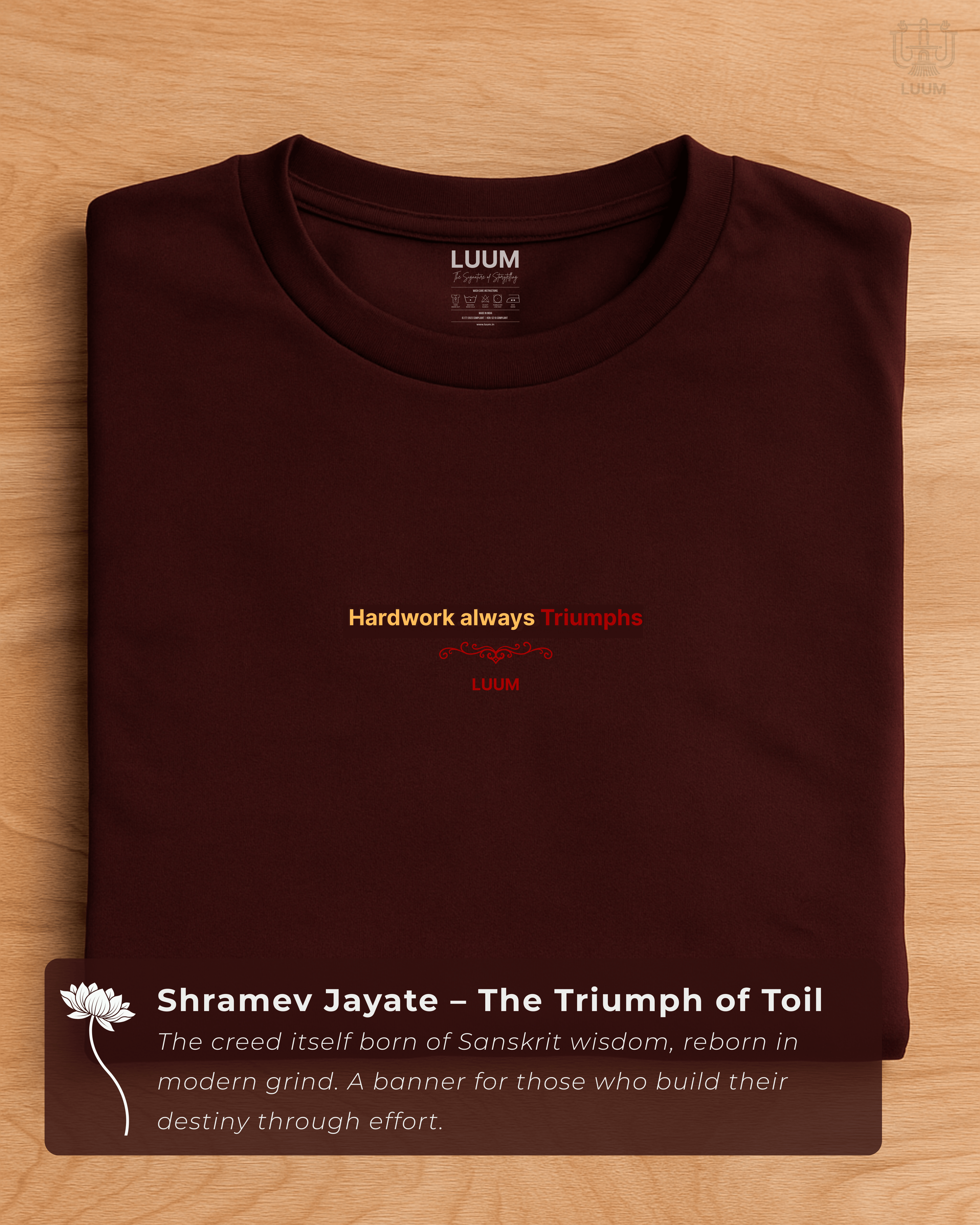 Folded maroon LUUM T-shirt with “Hardwork always Triumphs” motif, embodying the Sanskrit creed Shramev Jayate. Part of Threadmark Collection. Belief. Woven and Worn.