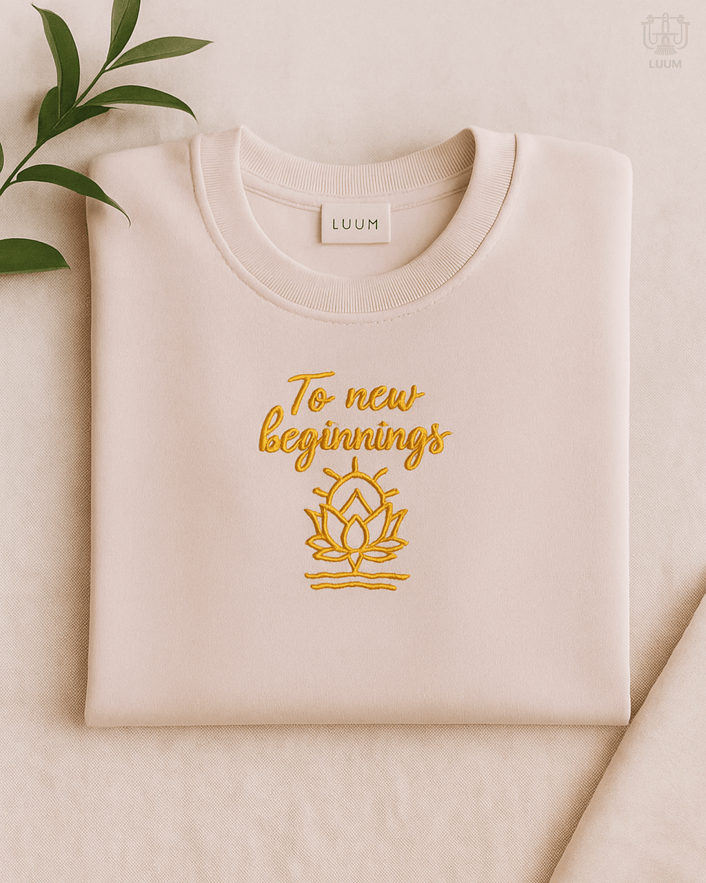 LUUM To New Beginnings embroidered Supima cotton tee in light baby pink with lotus design. Part of Threadmark Collection. Belief. Woven and Worn.