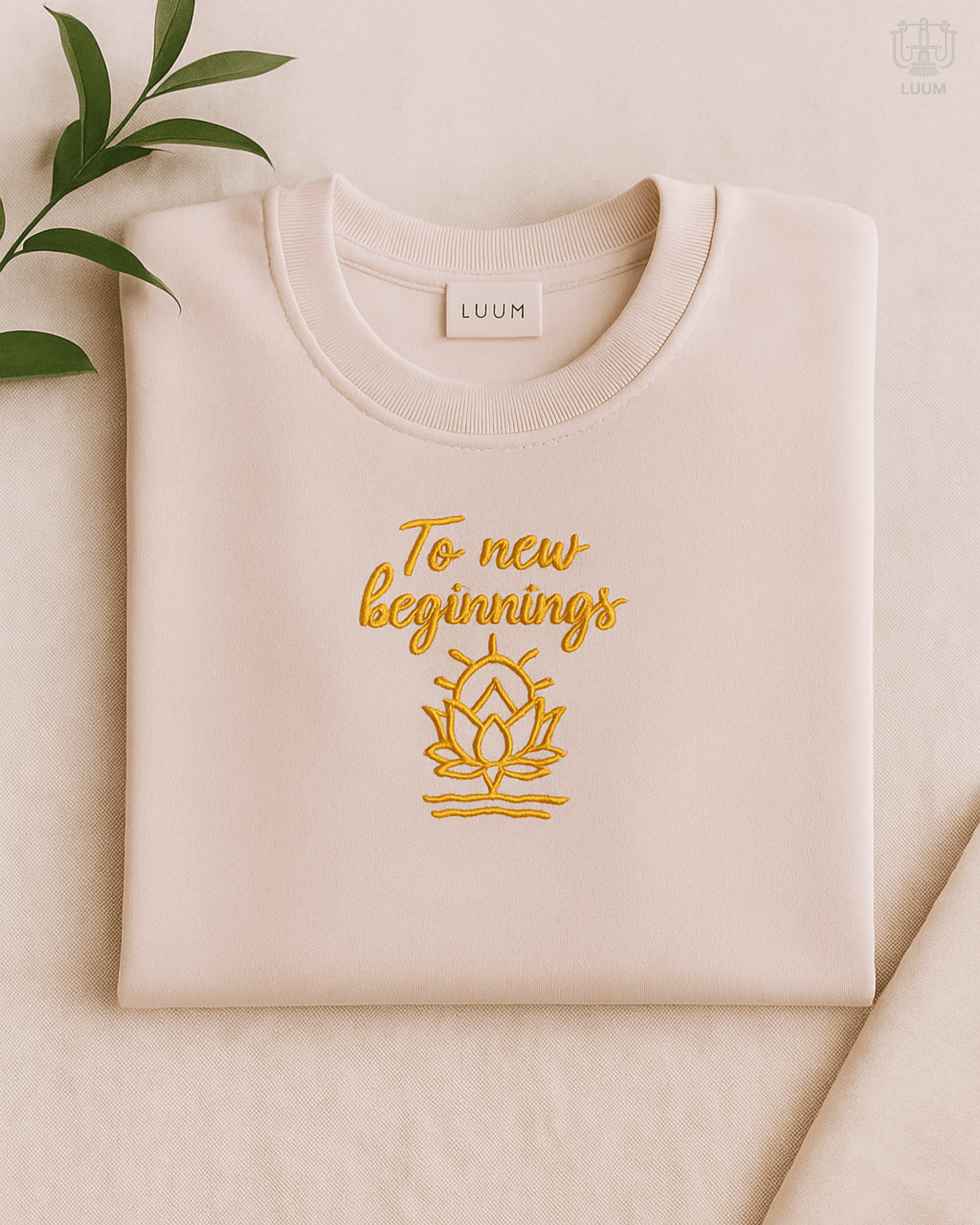 LUUM To New Beginnings embroidered Supima cotton tee in light baby pink with lotus design. Part of Threadmark Collection. Belief. Woven and Worn.