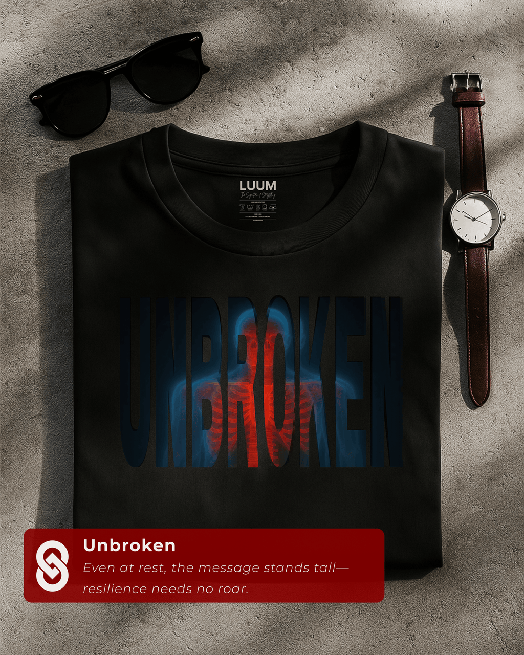 Folded black Unbroken t-shirt by LUUM, showcasing bold streetwear resilience design. Part of Threadmark Collection.