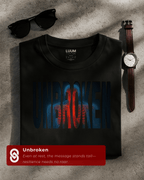 Folded black Unbroken t-shirt by LUUM, showcasing bold streetwear resilience design. Part of Threadmark Collection.