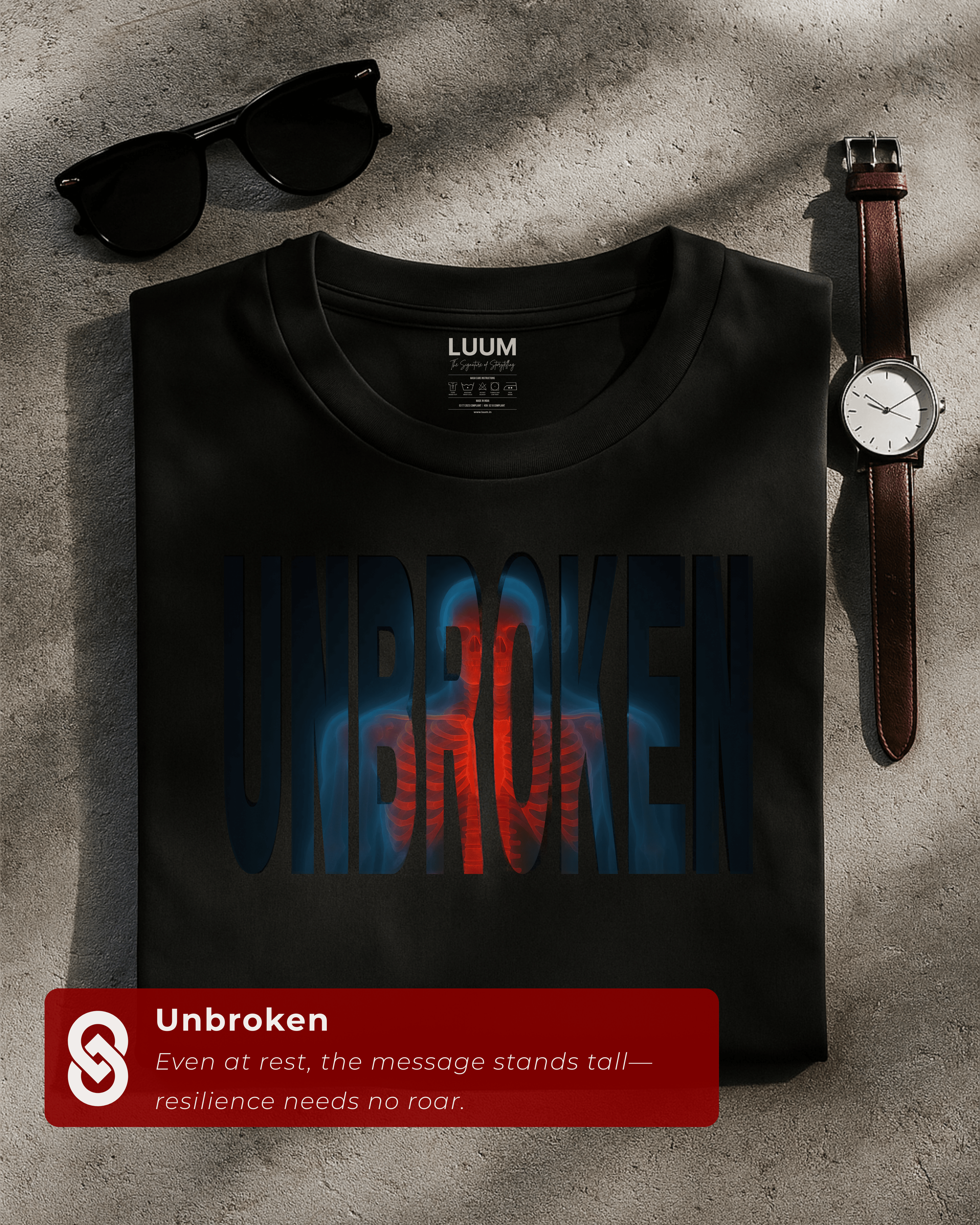 Folded black Unbroken t-shirt by LUUM, showcasing bold streetwear resilience design. Part of Threadmark Collection.